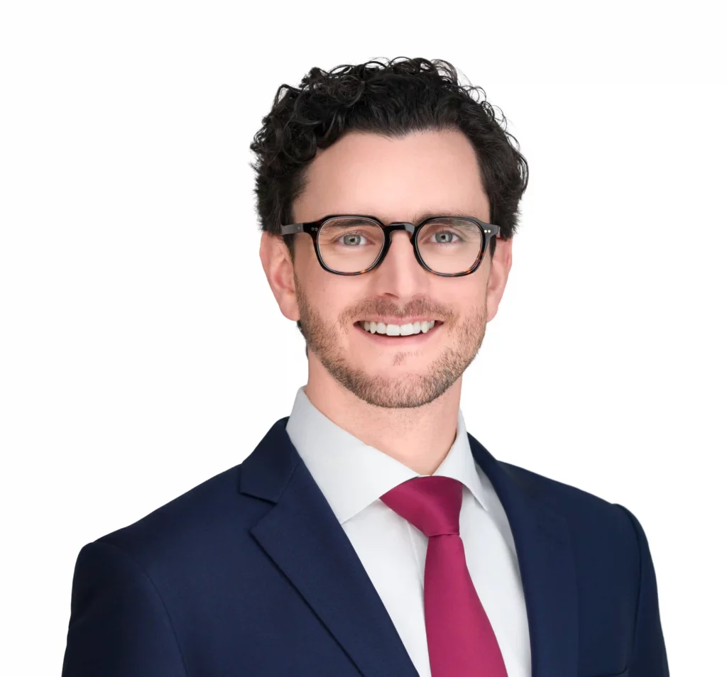 Corporate Headshot done by Corporate Headshot Photographer Headshot Specialist. Male is wearing a suit and Red tie