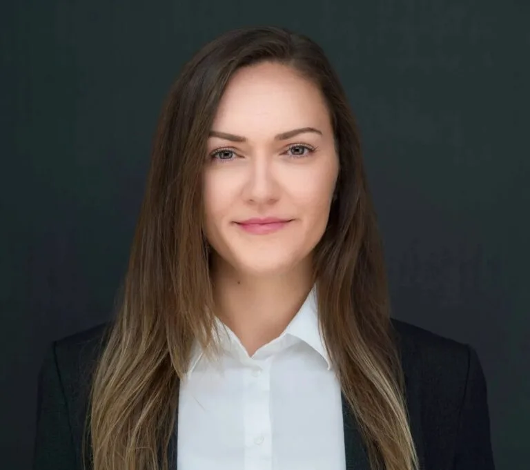 Headshot a woman with long hair wearing a suit and white shirt taken by Headshot Specialist Ray Singh in NYC. Headshots NYC