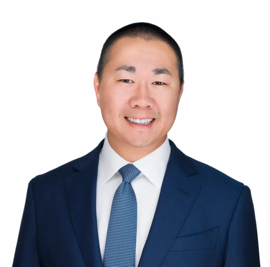 Corporate Headshot done by Corporate Headshot Photographer Headshot Specialist. Man is wearing a blue coat and Blue tie